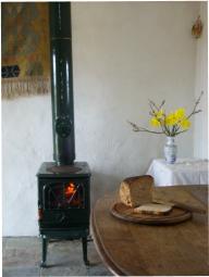 Fire burning in the woodstove, a loaf of bread on the table