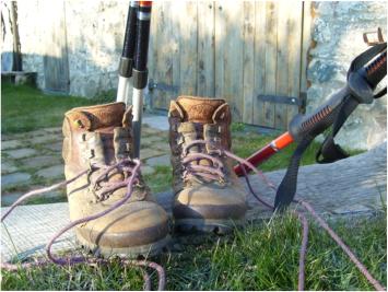 Boots and walking poles ready for use outside the Cwtsh