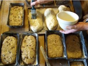 Breadmaking: eight loaves nearly ready for the oven